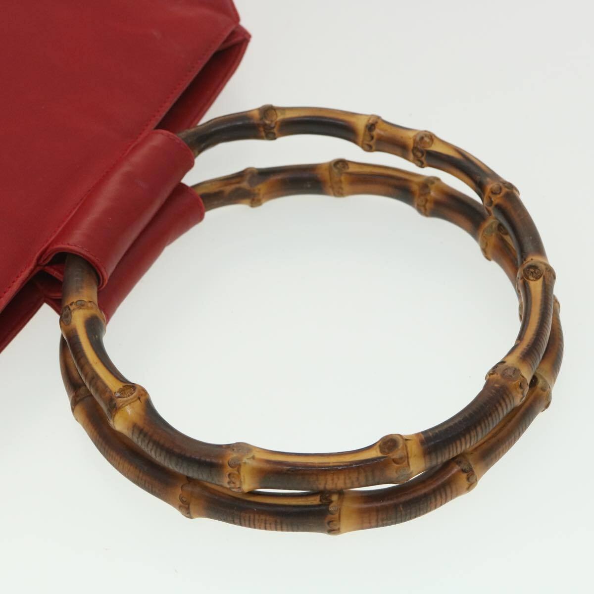 Vintage, mod look, Gucci, true red leather shopper with two round bamboo handles, a footed bottom, and gold accents