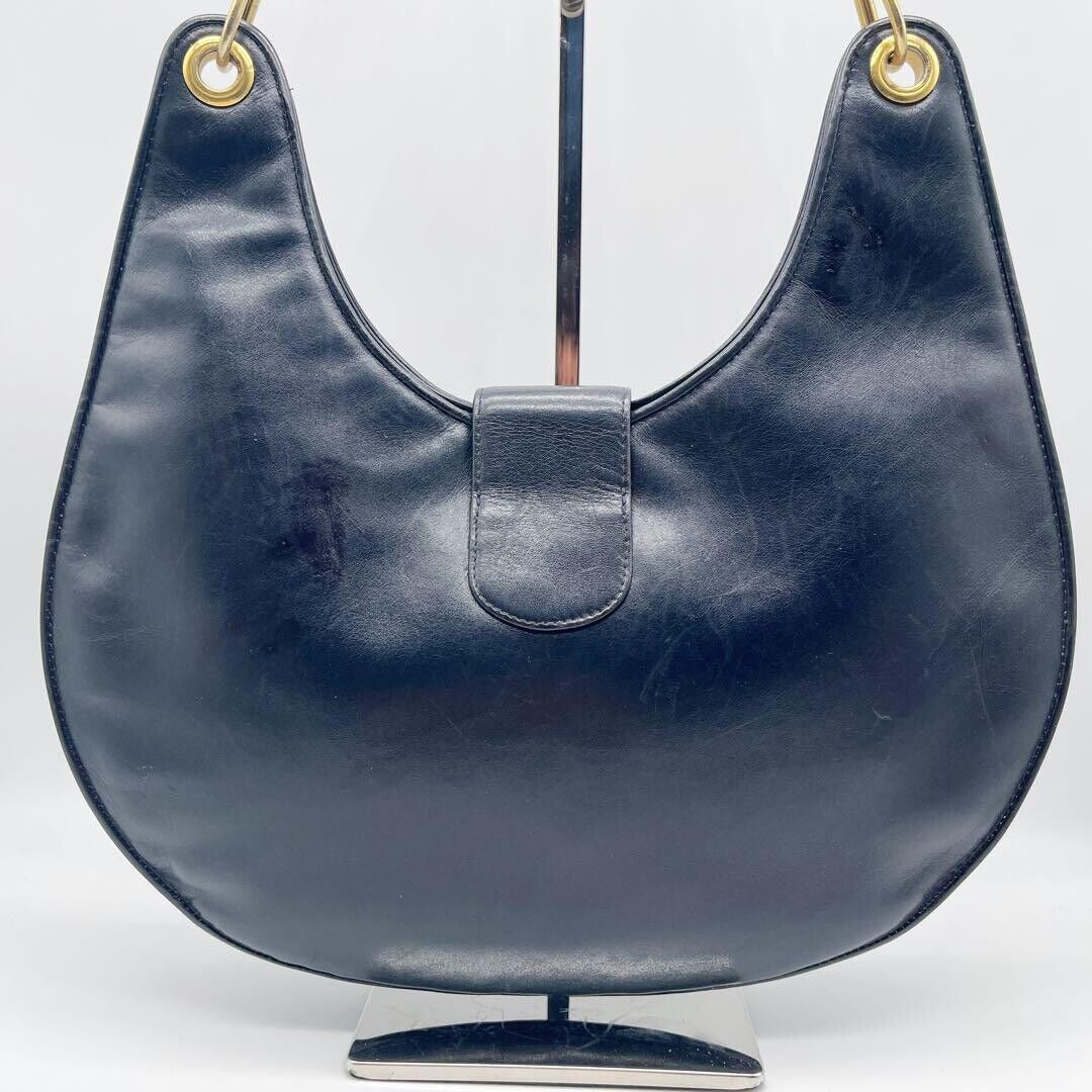 Vintage, rare, midnight blue leather, Gucci shoulder bag with a large, two-tone 'GG' emblem and removable strap