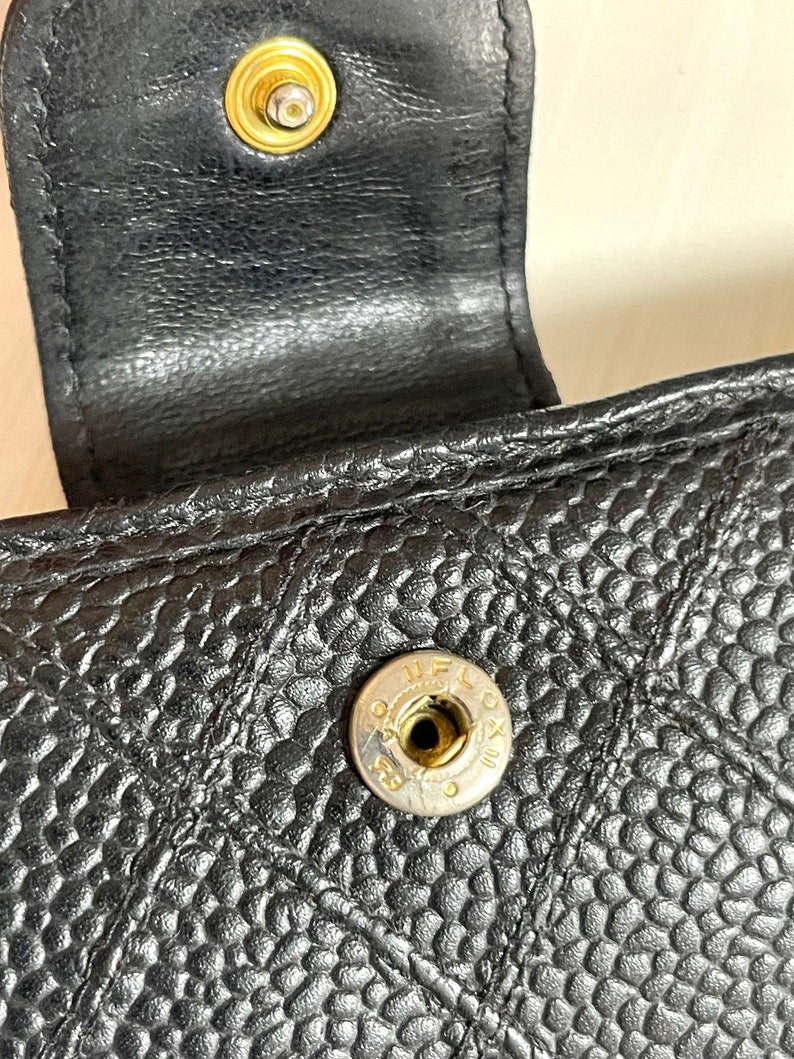 Chanel Vintage black caviar leather wallet with stitches and gold tone CC motif
